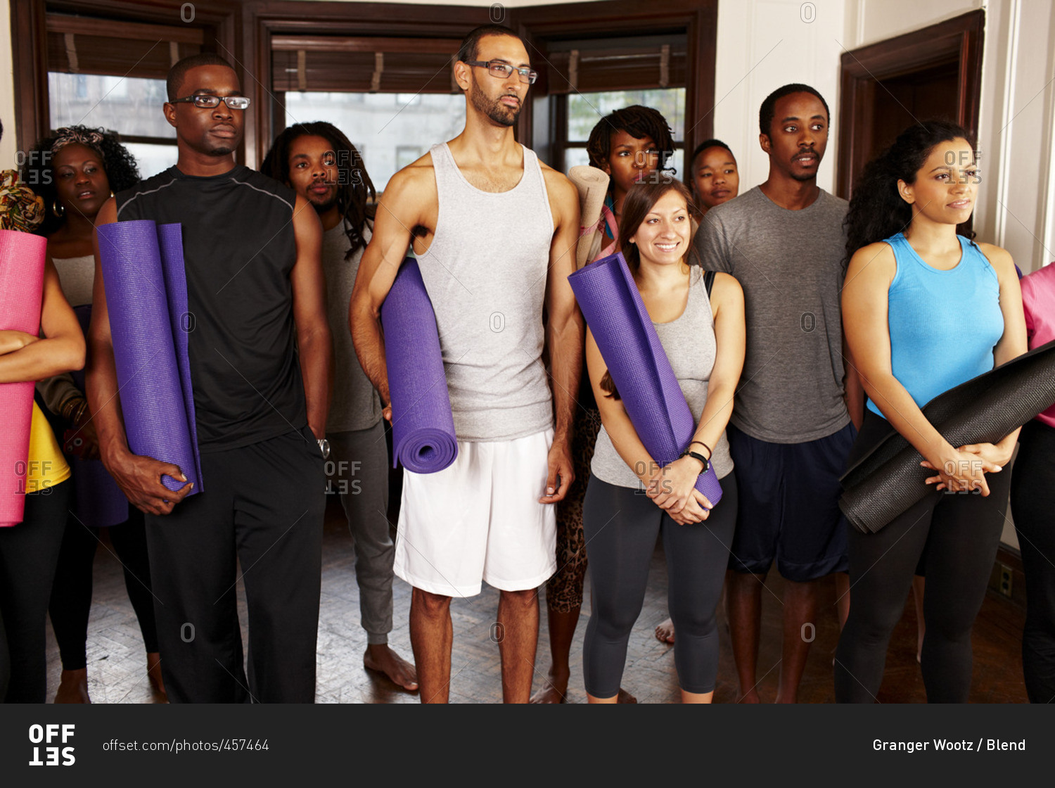 People holding yoga mats