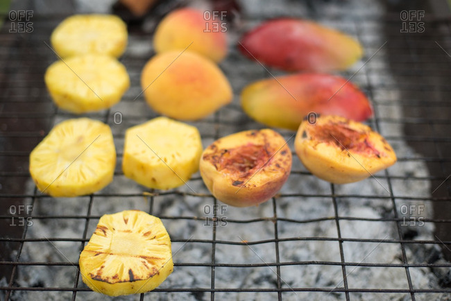 Pieces of fruit cooking on grill