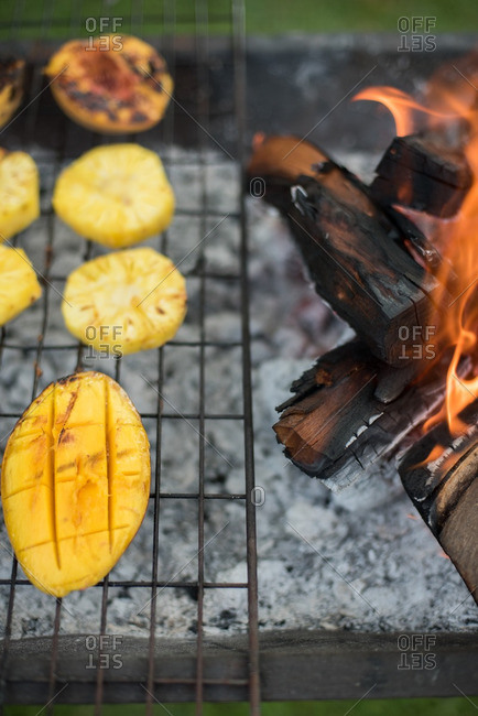 Fruit cooking on grill by flame