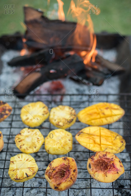 Fruit cooking on a grill by flame