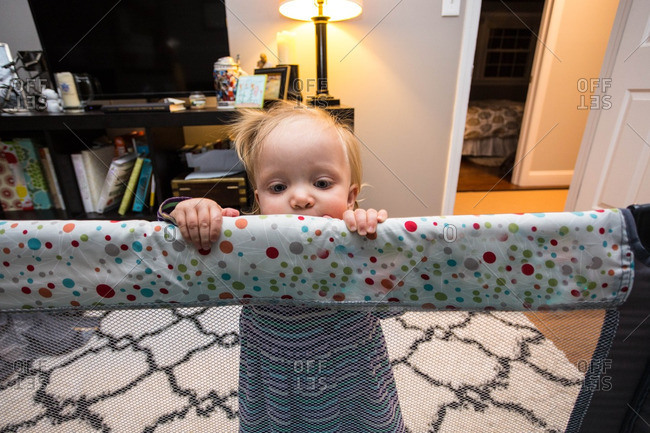 A Young Caucasian Toddler Girl Plays On Her Portable Travel Crib