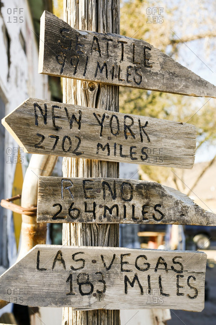 Directions carved in wood arrows on a post
