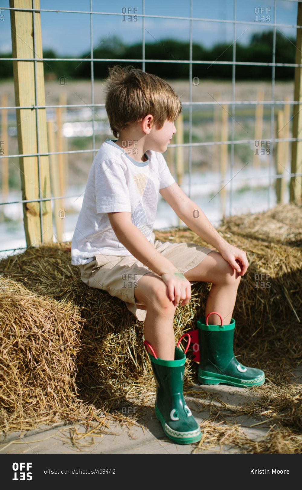 Boy sitting on a hay bale on a hay ride