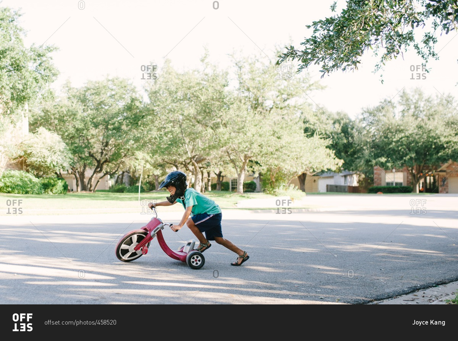 Boy playing with a low rider tricycle