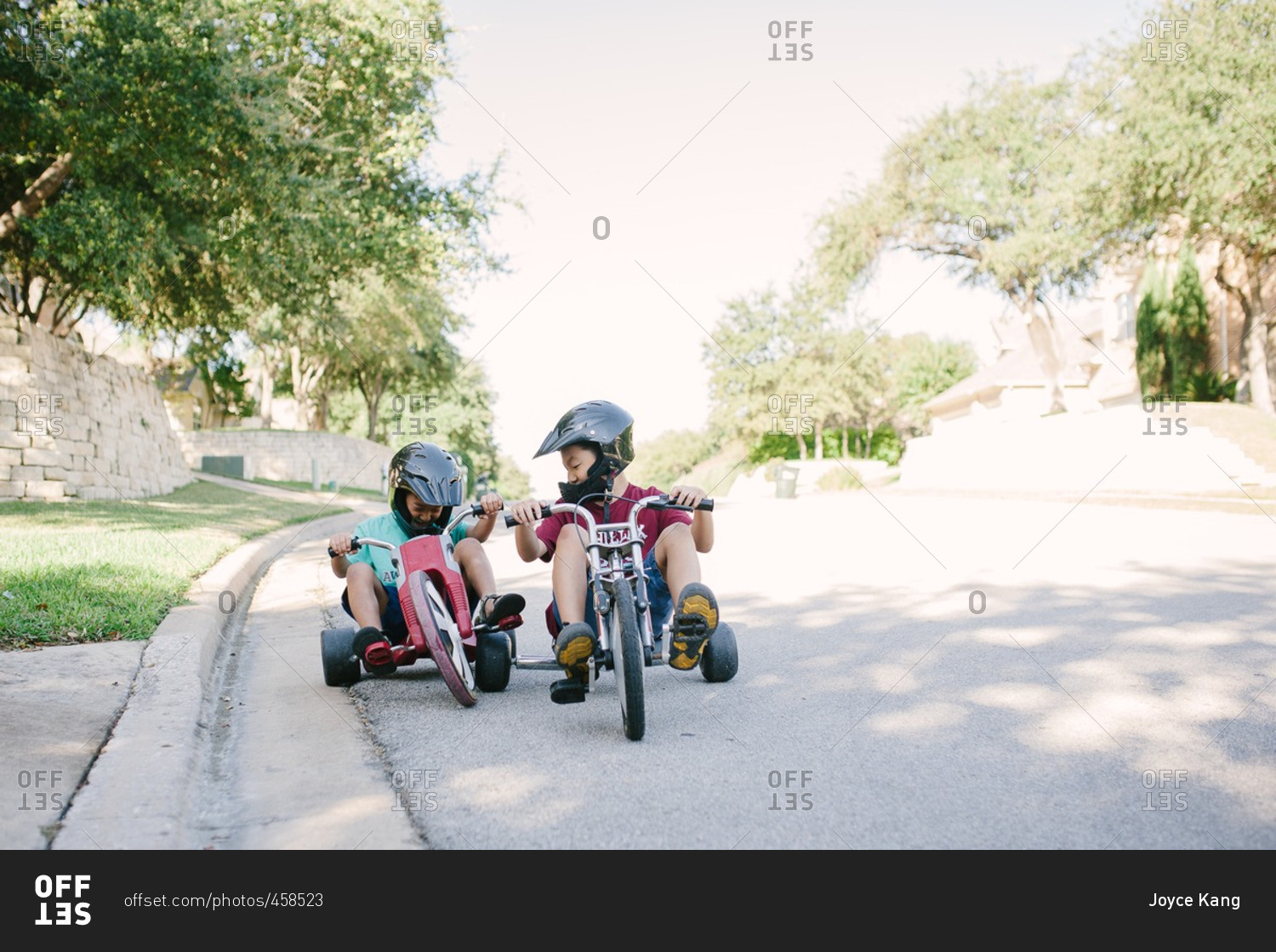 Two boys riding low rider tricycles