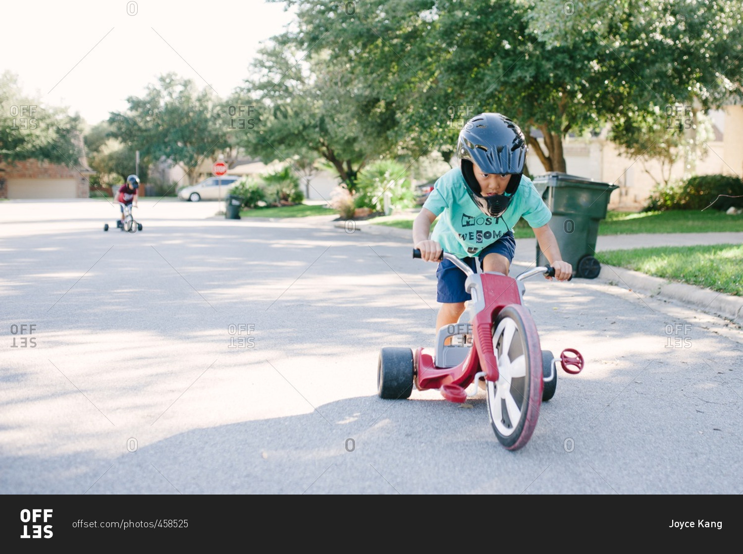 Young boy playing with a low rider tricycle