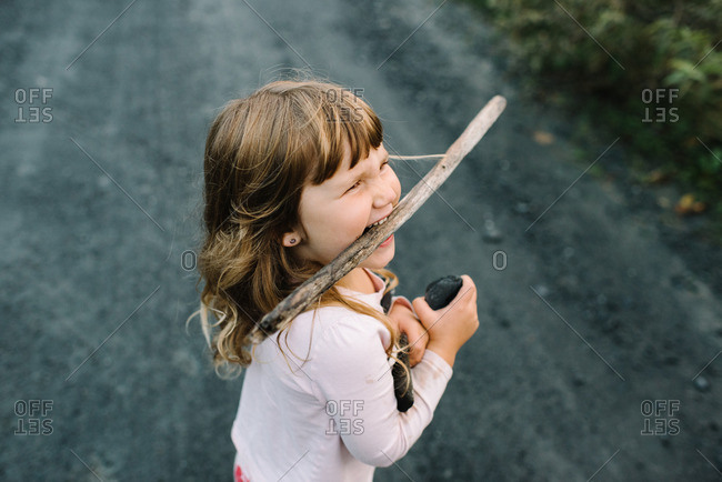 Girl with a stick in her mouth