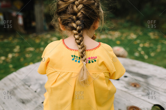 Girl in pigtail and embroidered shirt