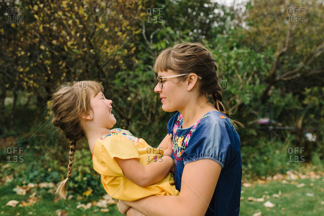 Happy mom and girl in embroidered shirts