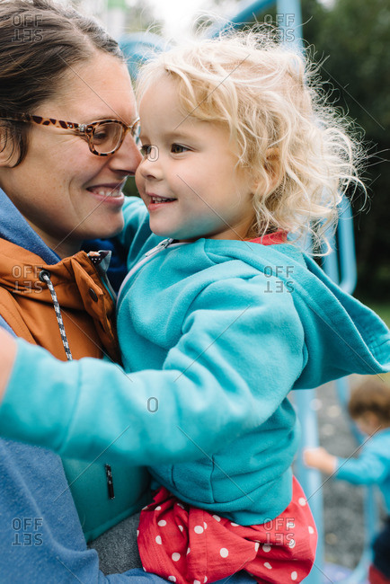 Woman holding a girl in playground