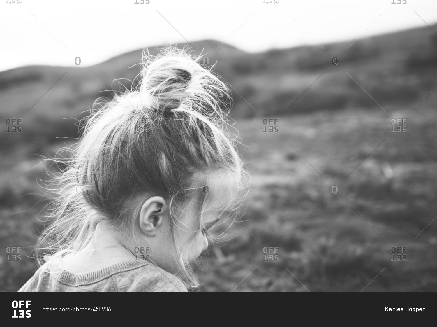 Little girl with a messy bun in black and white