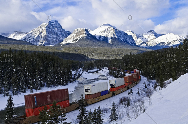 January 27, 2011: Train at Morant's curve with Haddo Peak, Saddle Mountain, Fairview Mountain in the background, Banff National Park, Alberta, Canada