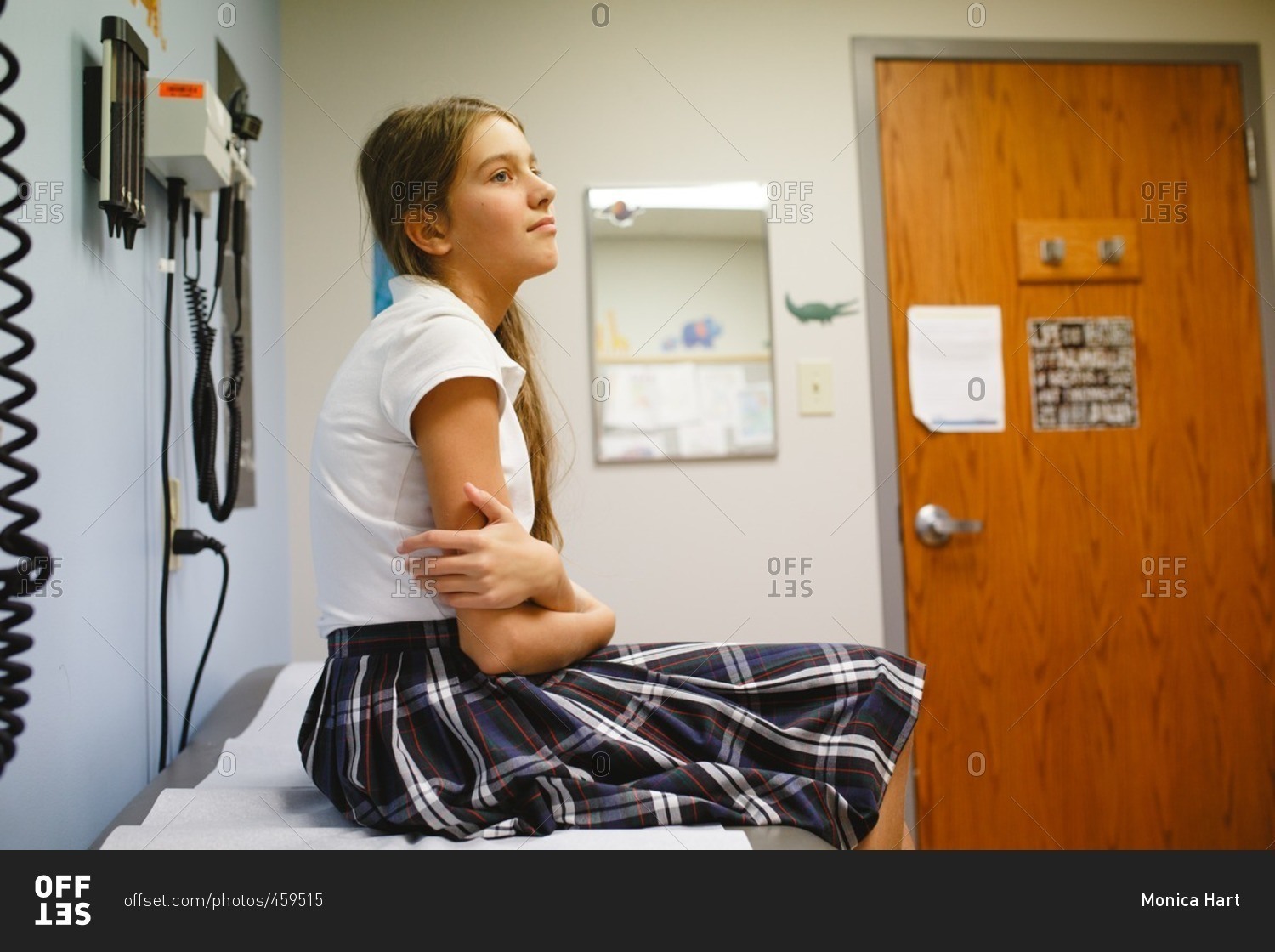 Tween girl at doctor's office wearing uniform