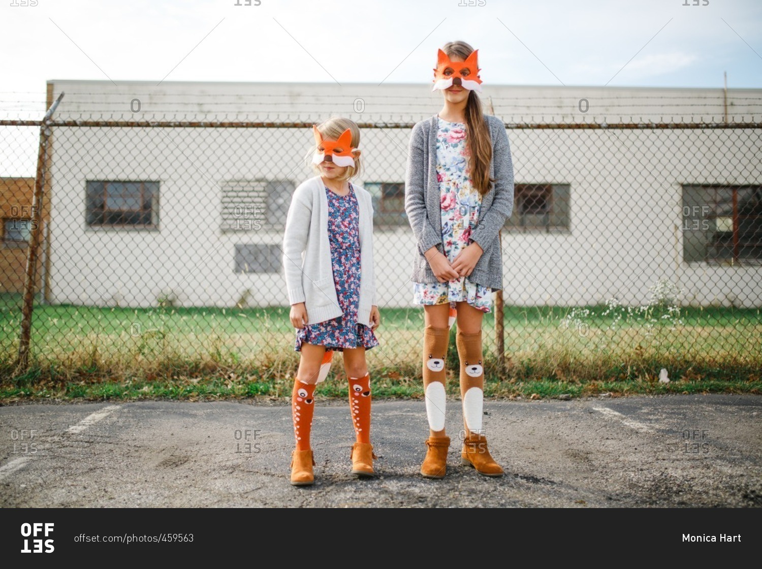Two girls wearing fox masks