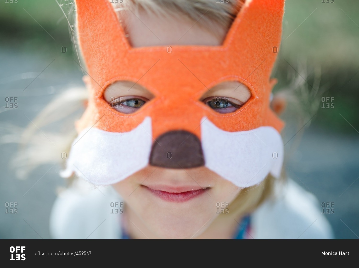 Close up of a little girl wearing a fox mask