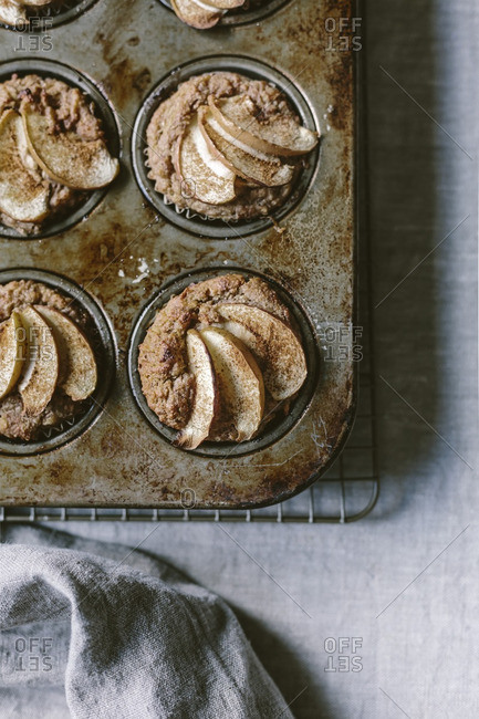 Freshly baked apple muffins that are still in the muffin tin
