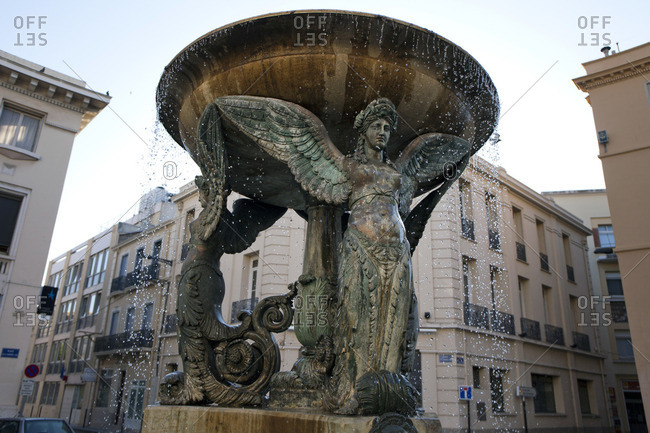 Fountain with statues in in Place Cardou Job in Perpignan, France.
