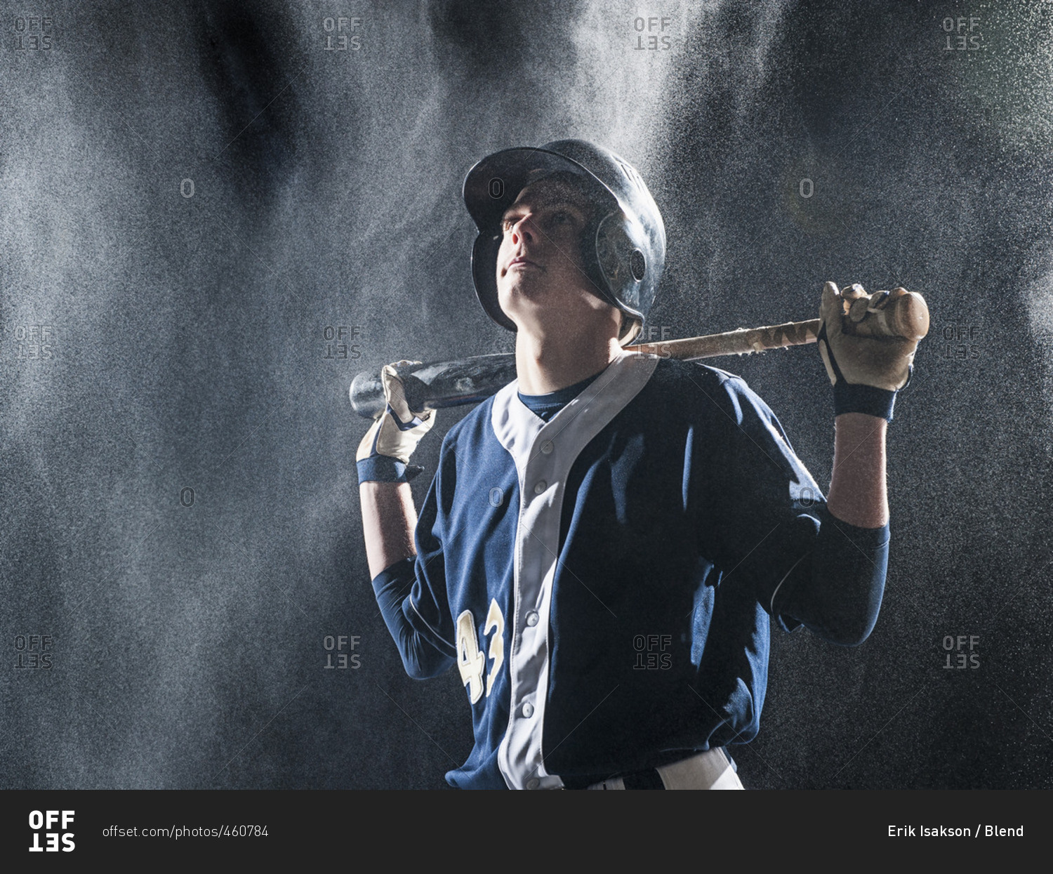 Caucasian baseball player standing in rain