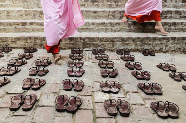 Nuns leaving sandals outside temple steps