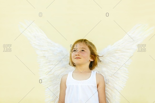 Smiling girl wearing angel wings