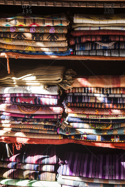 Stacks of folded woven textiles for sale in Antigua, Guatemala
