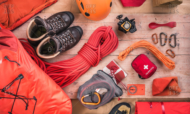 Overhead view of climbing equipment with climbing helmet, first aid kit, climbing boots and climbing ropes
