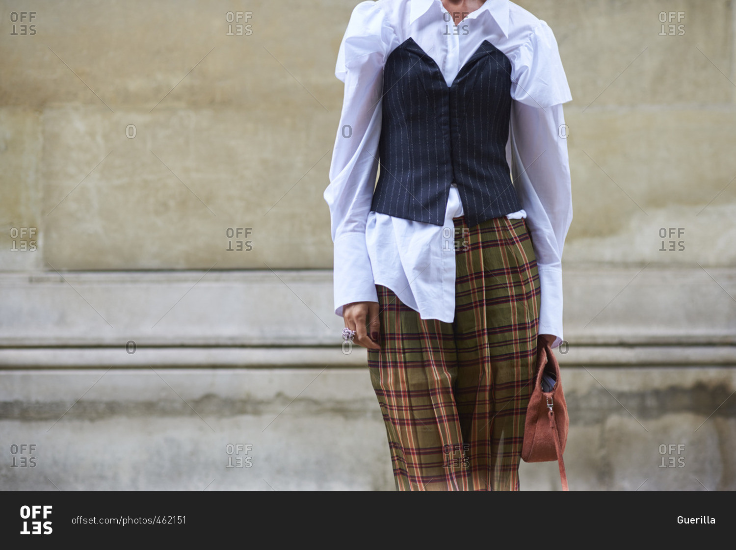 Woman in plaid trousers and bustier over white shirt
