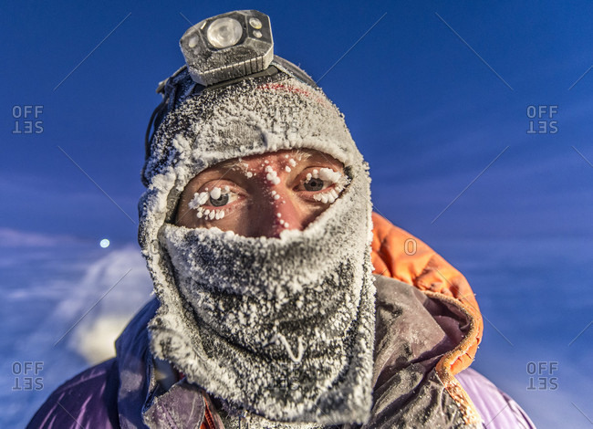Portrait Of Man With Headscarf And Flashlight In Antarctica With Ice On His Face
