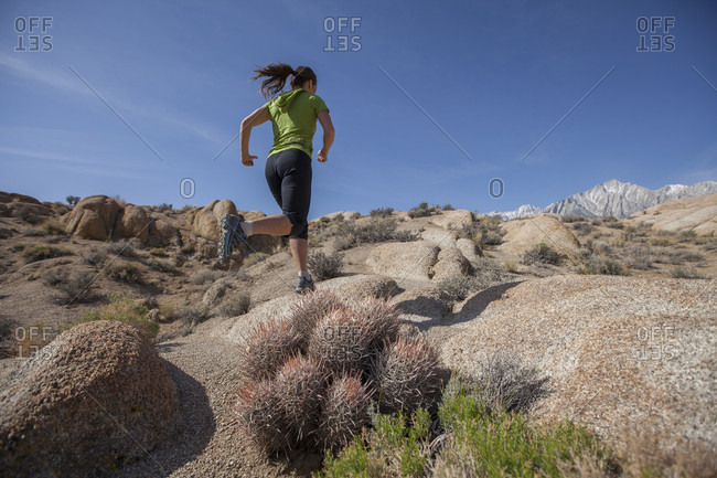 Woman Trail Running In The Alabama Hills National Recreation Area, Lone Pine, California, Usa
