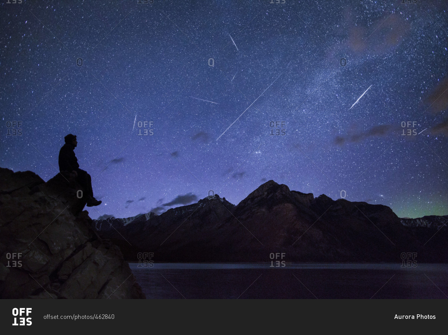 Silhouette Of Man Looking At Shooting Stars Near Lake Minnewanka