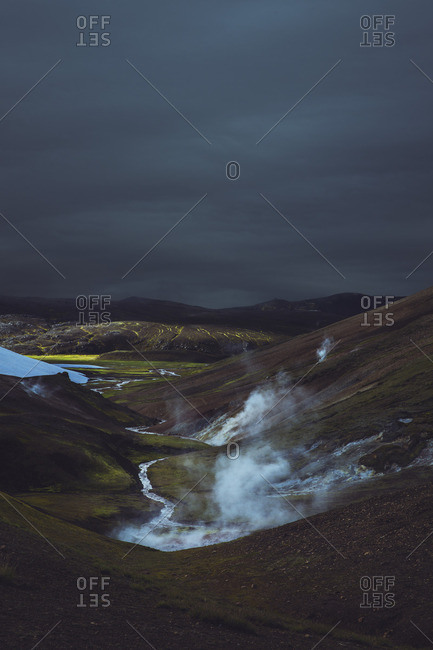 Stormy clouds over mountains and river in Iceland