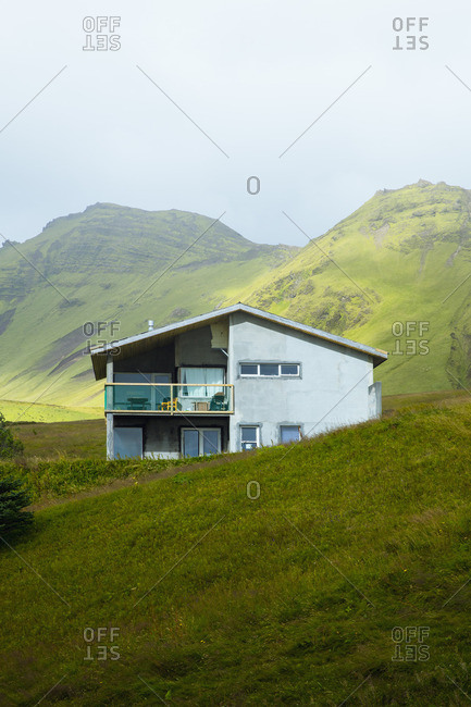 House in green mountains, Vik, Iceland