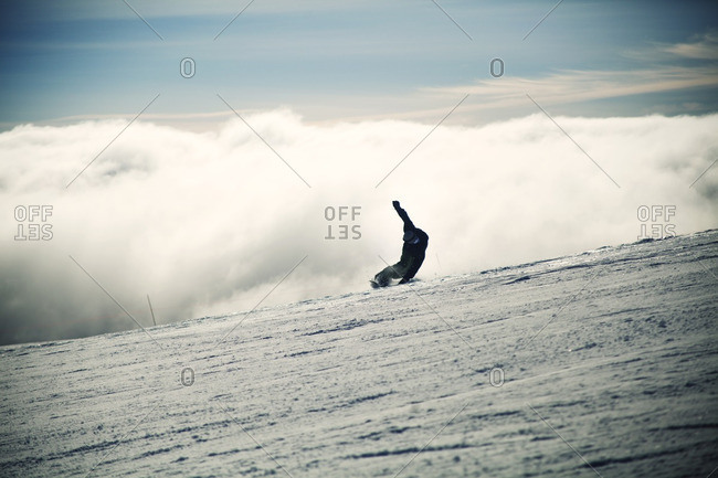 Man snowboarding on snowy landscape during foggy weather