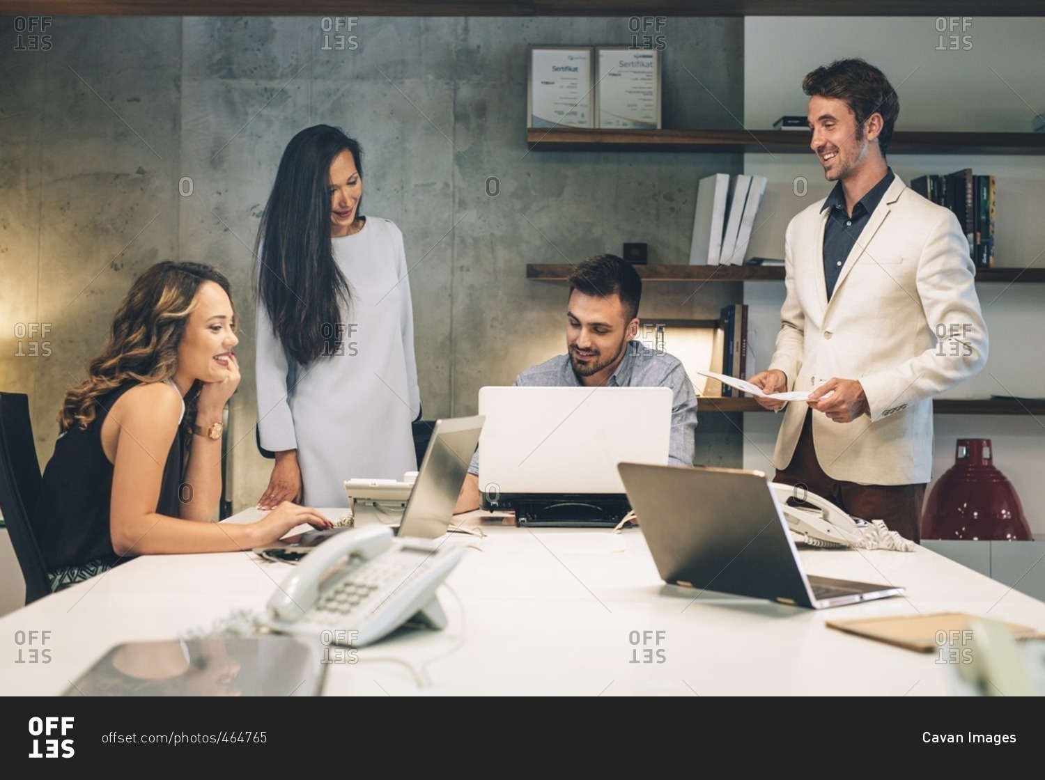 Business people discussing at desk in illuminated office