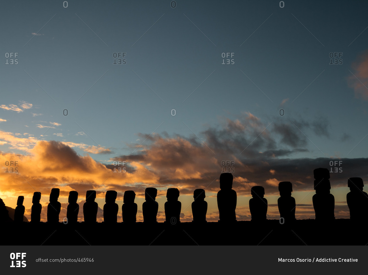 Cloudy sunrise behind Moai of Ahu Tongariki on Easter Island, Chile