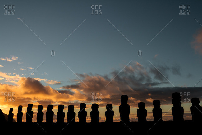 Cloudy sunrise behind Moai of Ahu Tongariki on Easter Island, Chile