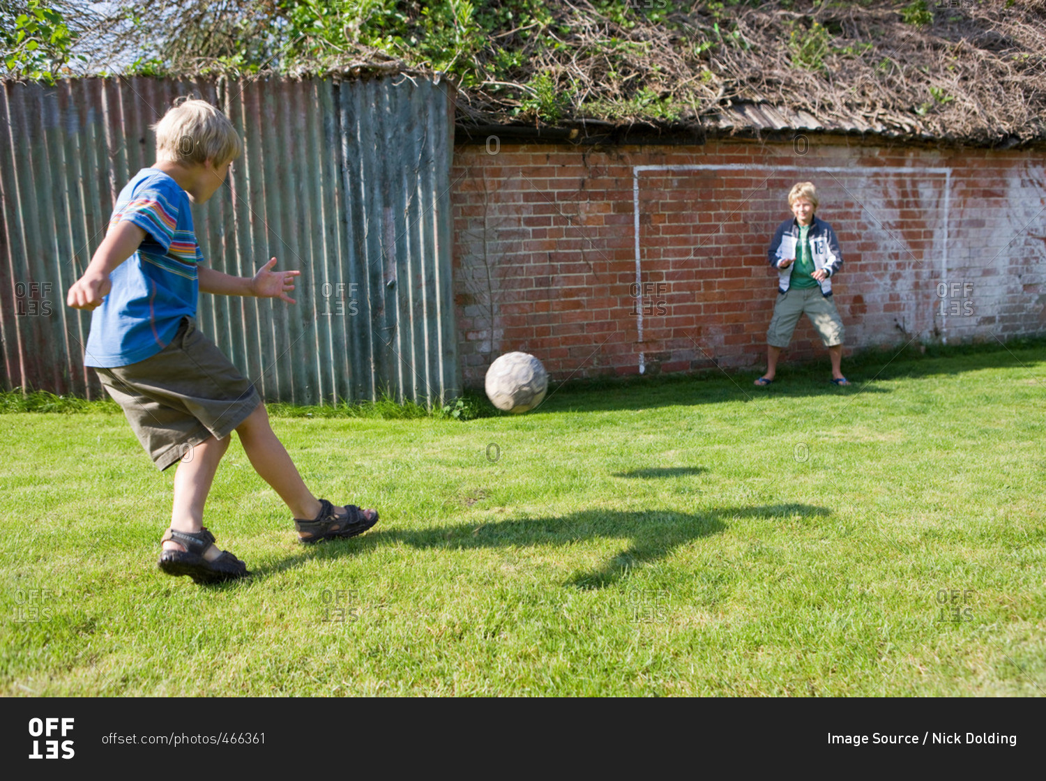 Child footballer shooting at goal