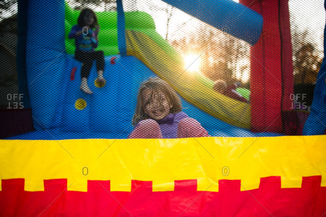 Little girl playing in a colorful bounce house