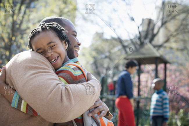 Boy hugging his mother around the waist stock photo - OFFSET