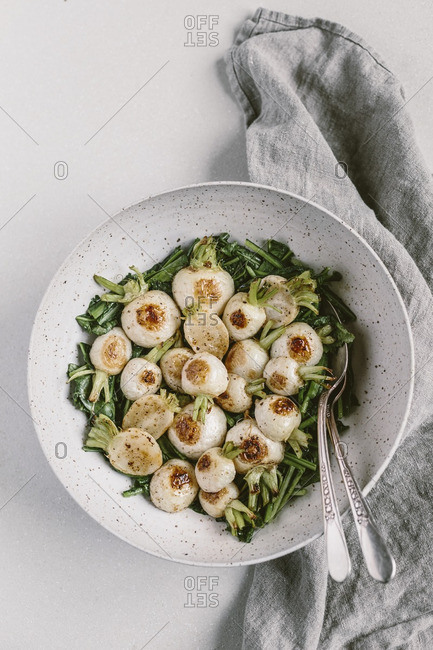 Bowl of roasted Japanese turnips and saut�ed greens