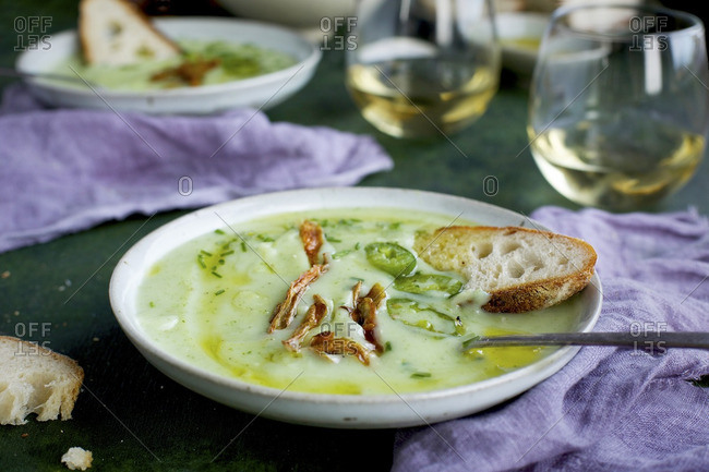 Cream of potato chive soup with potato skins, jalapenos and bread