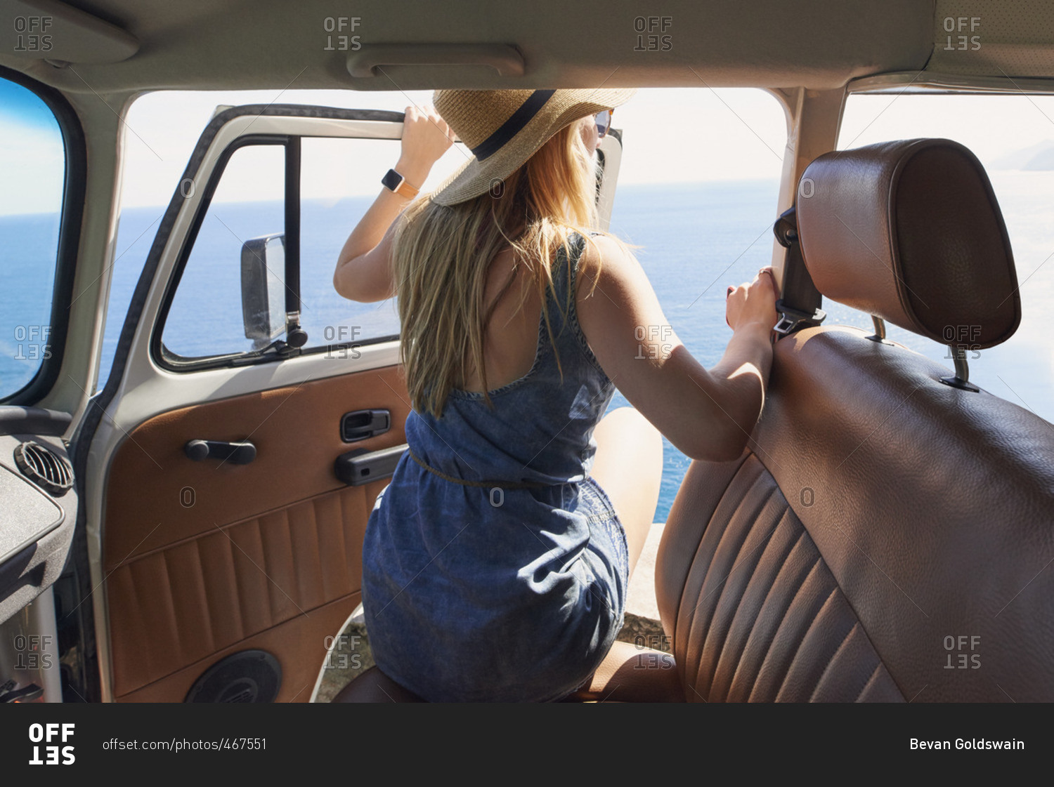 Woman looking out van at Mediterranean
