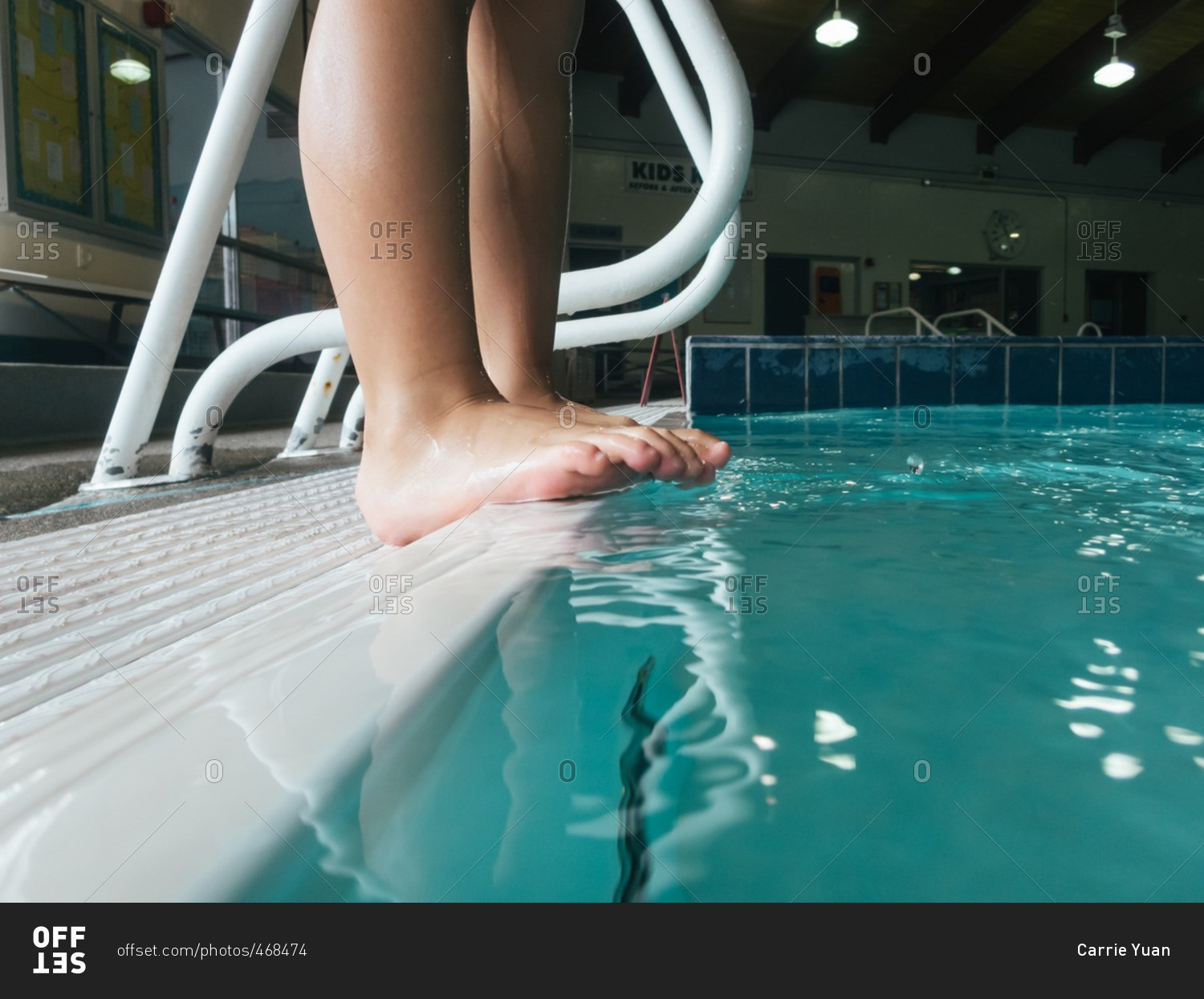 Child's bare feet by swimming pool stock photo OFFSET