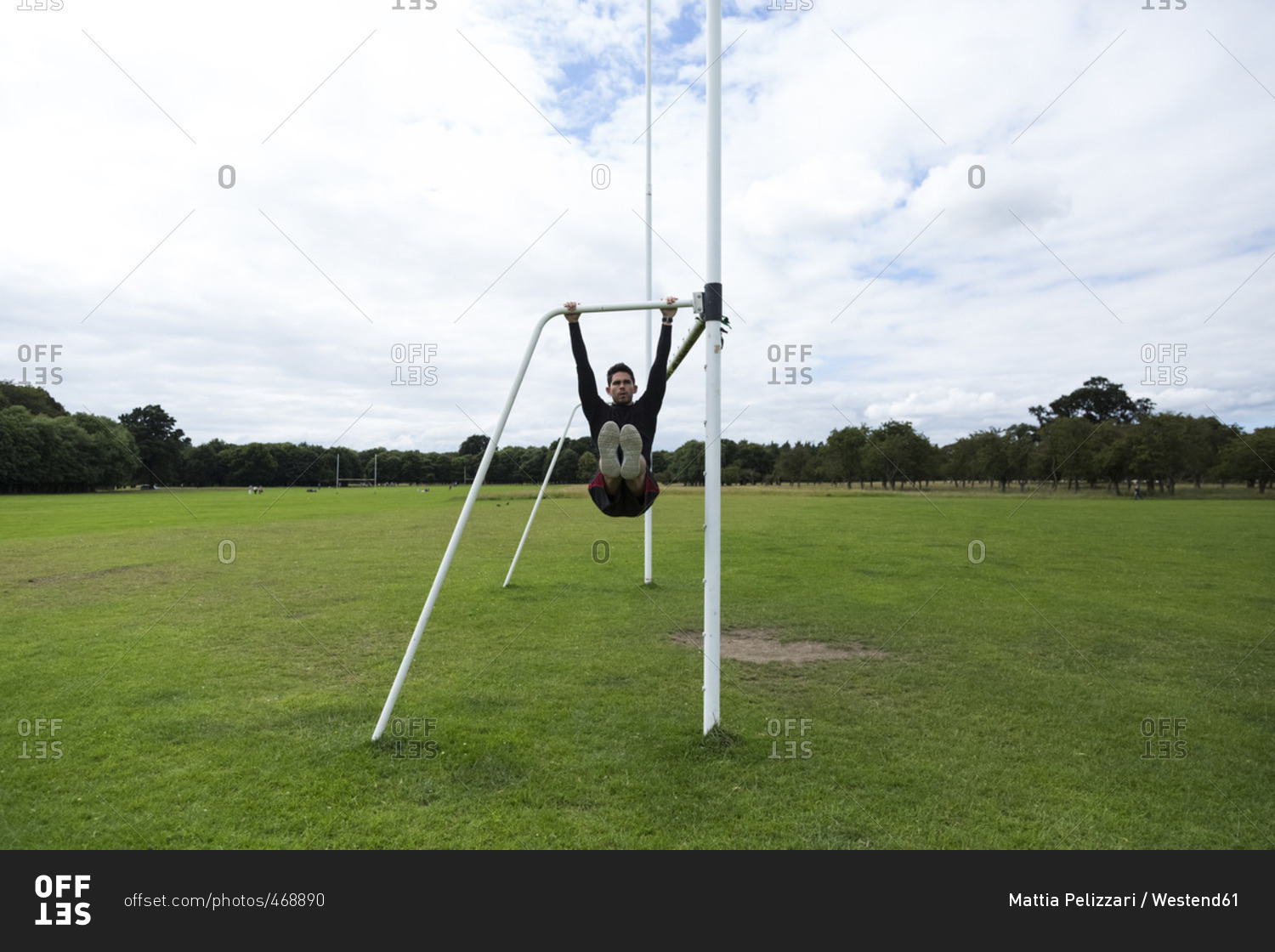 Athlete exercising on goal on sports field