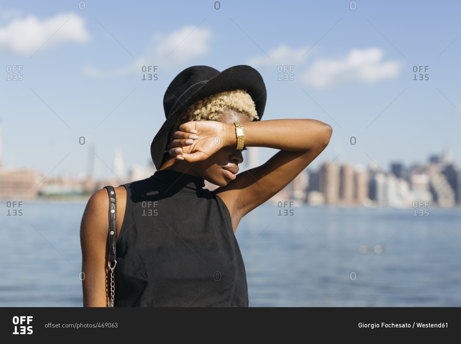 USA- New York City- Brooklyn- young woman at East River wearing a hat