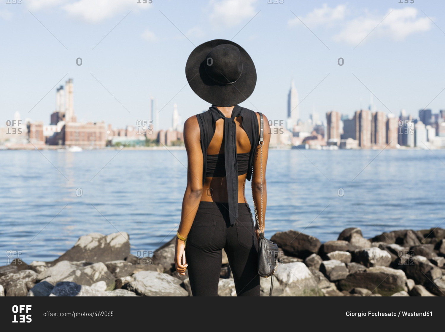USA- New York City- Brooklyn- young woman standing at East River