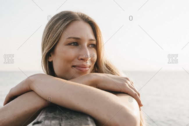 Portrait of happy young woman at the sea