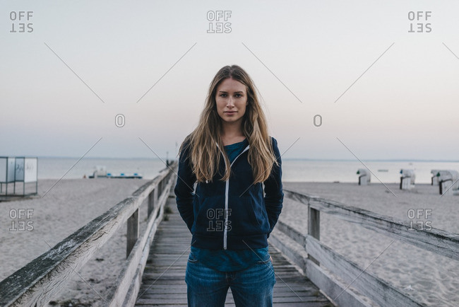 Portrait of young woman standing on jetty