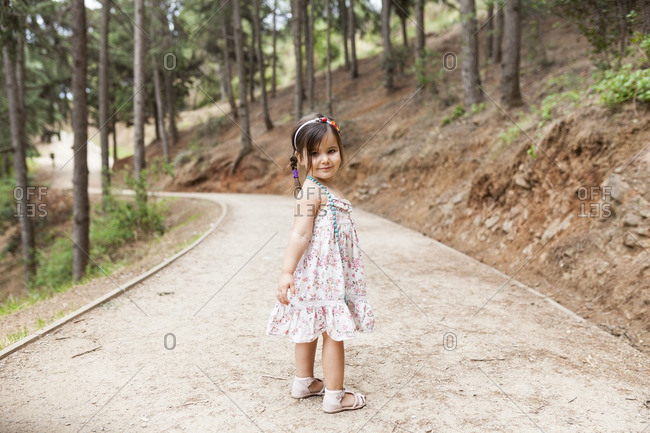 Little girl standing on forest track