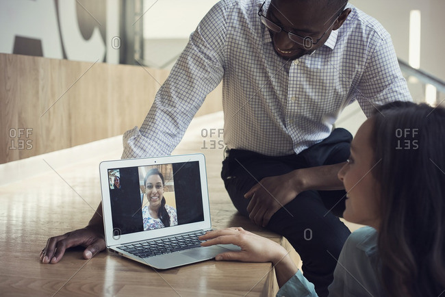 Business people having a video conference on laptop
